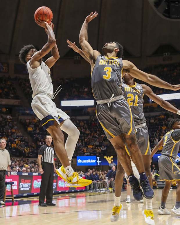 Dec 12, 2021; Morgantown, West Virginia, USA; West Virginia Mountaineers guard Taz Sherman (12) shoots a jumper over Kent State Golden Flashes guard Sincere Carry (3) during the second half at WVU Coliseum. Mandatory Credit: Ben Queen-USA TODAY Sports